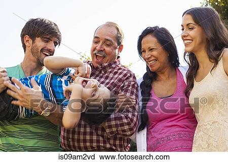 Three generation family in garden View Large Photo Image Stock Image - Three generation family in garden. Fotosearch