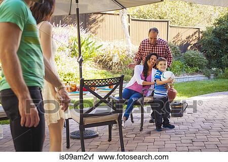 Three generation family in garden View Large Photo Image Stock Image - Three generation family in garden. Fotosearch