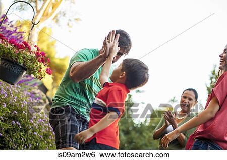 Three generation family playing in garden View Large Photo Image Stock Photograph - Three generation family playing in garden. Fotosearch