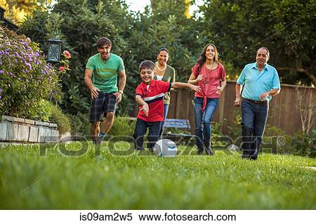Three generation family playing football in garden View Large Photo Image Stock Photography - Three generation family playing football in garden. Fotosearch