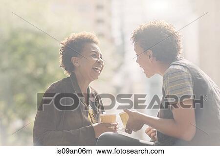 Two mature female friends chatting on street View Large Photo Image Picture - Two mature female friends chatting on street. Fotosearch