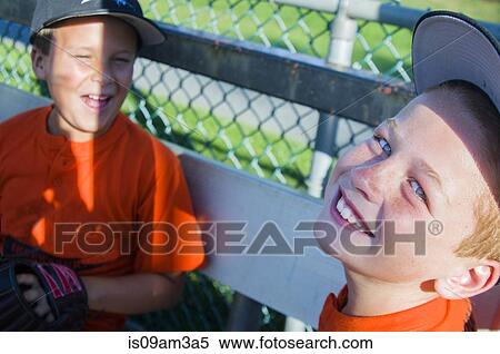 Two young male baseball players laughing together View Large Photo Image Stock Photography - Two young male baseball players laughing together. Fotosearch