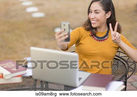 Woman taking selfie with smartphone View Large Photo Image Stock Image - Woman taking selfie with smartphone. Fotosearch