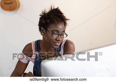 Woman working at computer View Large Photo Image Stock Photo - Woman working at computer. Fotosearch