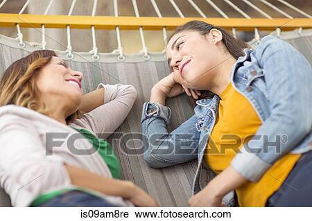 Women lying on hammock View Large Photo Image Stock Image - Women lying on hammock. Fotosearch
