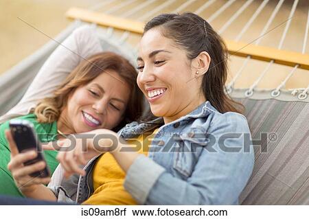 Women lying on hammock View Large Photo Image Stock Image - Women lying on hammock. Fotosearch