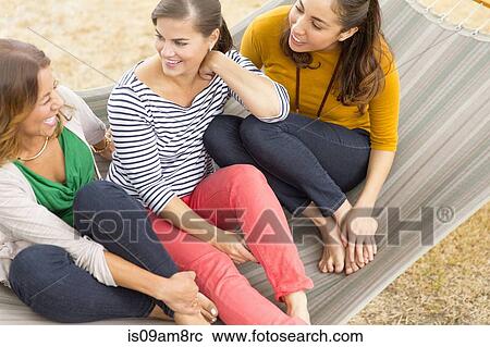 Women sitting on hammock View Large Photo Image Stock Image - Women sitting on hammock. Fotosearch