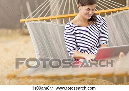 Women using laptop on hammock View Large Photo Image Stock Photo - Women using laptop on hammock. Fotosearch