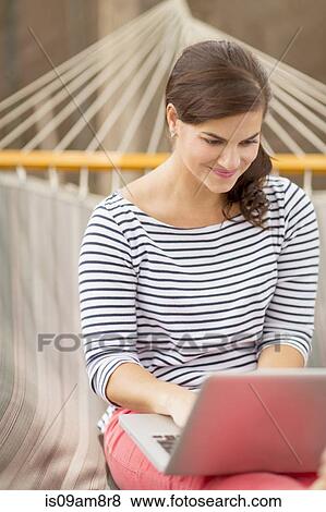 Women using laptop on hammock View Large Photo Image Stock Photo - Women using laptop on hammock. Fotosearch