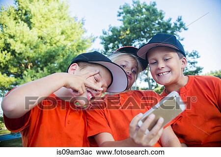 Young baseball players taking self portrait using smartphone View Large Photo Image Stock Image - Young baseball players taking self portrait using smartphone. Fotosearch