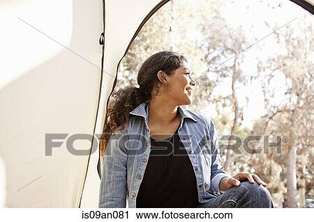 Young woman looking from tent entrance View Large Photo Image Stock Image - Young woman looking from tent entrance. Fotosearch
