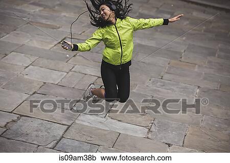 "Young woman, outdoors, listening to music and dancing" View Large Photo Image Stock Image - "Young woman, outdoors, listening to music and dancing". Fotosearch