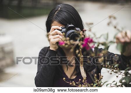 "Young woman taking photographs, outdoors" View Large Photo Image Stock Image - "Young woman taking photographs, outdoors". Fotosearch