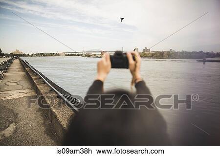 "Young woman taking photographs, outdoors, rear view" View Large Photo Image Stock Image - "Young woman taking photographs, outdoors, rear view". Fotosearch
