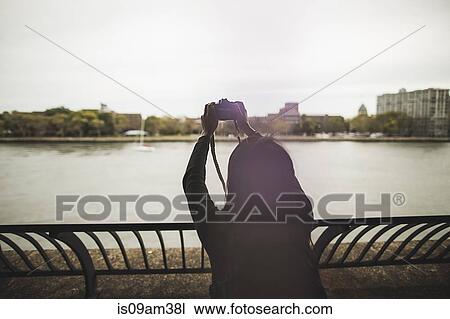 "Young woman taking photographs, outdoors, rear view" View Large Photo Image Stock Image - "Young woman taking photographs, outdoors, rear view". Fotosearch