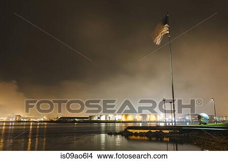 Picture - "American flag on waterfront of Puget Sound at night, Tacoma, Washington State, USA". Fotosearch