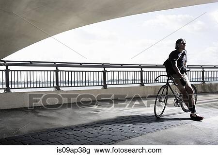 Bike messenger leaning on bike View Large Photo Image Stock Image - Bike messenger leaning on bike. Fotosearch