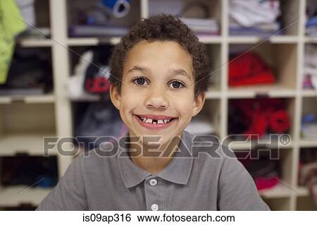 "Boy with wide smile, shelves in background" View Large Photo Image Stock Photograph - "Boy with wide smile, shelves in background". Fotosearch