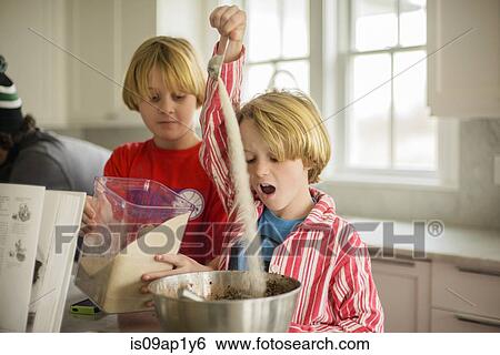 Brothers pouring flour into mixing bowl in kitchen View Large Photo Image Stock Photograph - Brothers pouring flour into mixing bowl in kitchen. Fotosearch