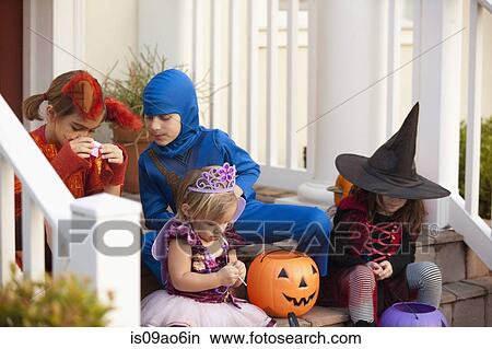 Picture - Children enjoying treats on steps. Fotosearch