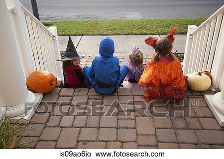 Picture - Children enjoying treats on steps. Fotosearch