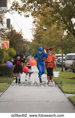 Stock Image - Children going trick or treating. Fotosearch