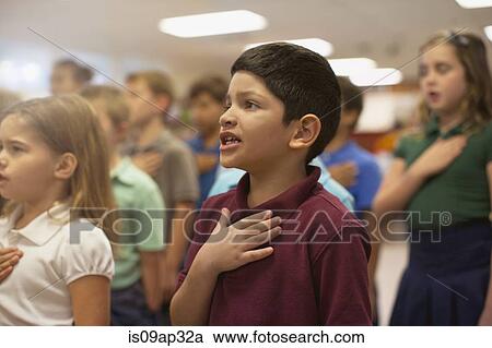 Stock Image - Children reciting Pledge of Allegiance in school. Fotosearch