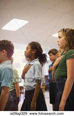 Stock Photo - Children reciting Pledge of Allegiance in school. Fotosearch