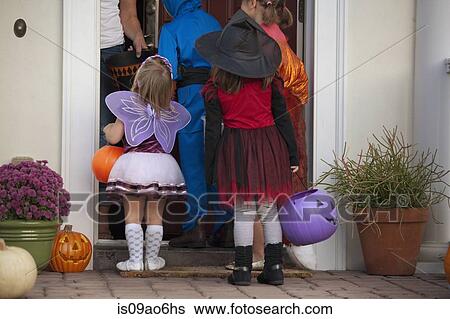 Stock Photograph - Children trick or treating. Fotosearch