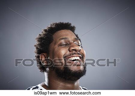 Close up studio portrait of mid adult man laughing View Large Photo Image Picture - Close up studio portrait of mid adult man laughing. Fotosearch