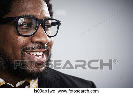 Stock Image - Close up studio portrait of mid adult businessman looking sideways. Fotosearch