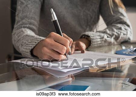 Cropped close up of young businesswoman making notes View Large Photo Image Stock Image - Cropped close up of young businesswoman making notes. Fotosearch