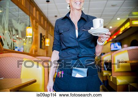 Cropped view of waitress carrying coffee cup in diner View Large Photo Image Picture - Cropped view of waitress carrying coffee cup in diner. Fotosearch