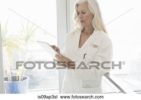 Doctor using digital tablet View Large Photo Image Stock Image - Doctor using digital tablet. Fotosearch