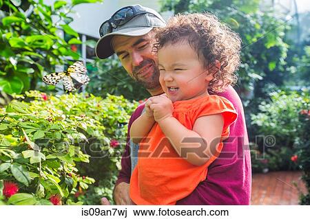 Father and daughter looking at butterfly View Large Photo Image Stock Image - Father and daughter looking at butterfly. Fotosearch