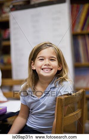 Picture - Girl smiling in classroom. Fotosearch