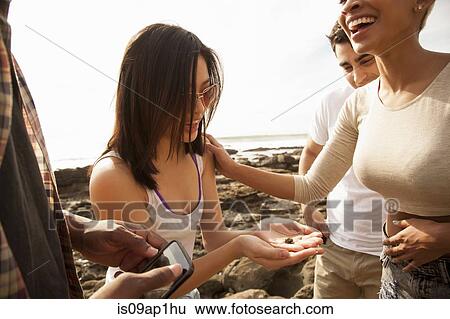 Group of friends fooling around on beach View Large Photo Image Stock Photograph - Group of friends fooling around on beach. Fotosearch