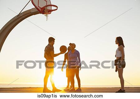 Stock Photograph - "Group of friends playing basketball, outdoors". Fotosearch