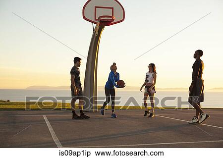 Stock Photography - "Group of friends playing basketball, outdoors". Fotosearch