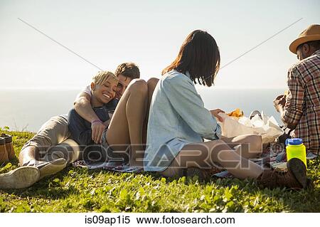 Stock Photography - Group of friends relaxing on grass. Fotosearch