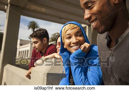 "Group of friends sitting together, outdoors" View Large Photo Image Stock Image - "Group of friends sitting together, outdoors". Fotosearch