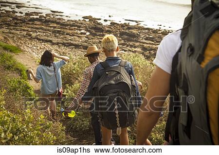"Group of friends walking down towards beach, rear view" View Large Photo Image Stock Photograph - "Group of friends walking down towards beach, rear view". Fotosearch