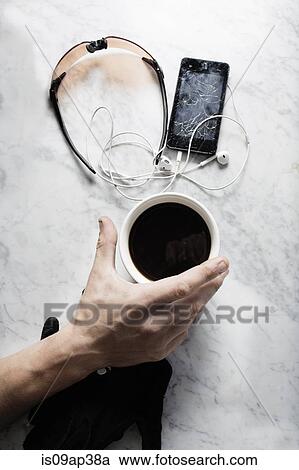 "Hand of bike messenger with coffee, glasses, broken smartphone" View Large Photo Image Stock Image - "Hand of bike messenger with coffee, glasses, broken smartphone". Fotosearch