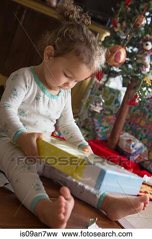 Little girl admiring Christmas gift View Large Photo Image Stock Photo - Little girl admiring Christmas gift. Fotosearch
