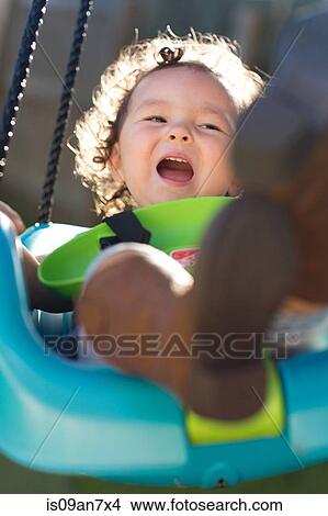 Picture - Little girl on swing. Fotosearch