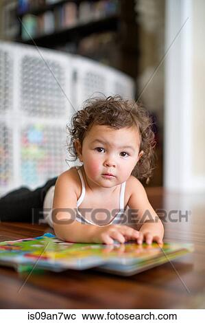 Little girl reading board book View Large Photo Image Stock Image - Little girl reading board book. Fotosearch