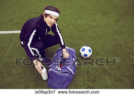 Stock Photo - Male soccer player preparing to play on soccer pitch. Fotosearch
