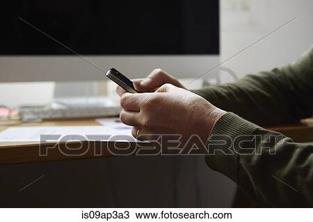 Stock Image - Man using smartphone. Fotosearch