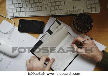Man writing out cheque View Large Photo Image Stock Photograph - Man writing out cheque. Fotosearch