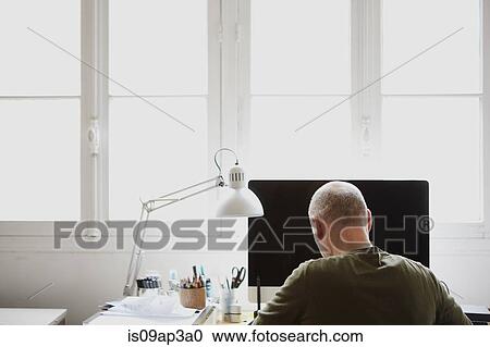 Stock Image - Mature man working in creative studio. Fotosearch